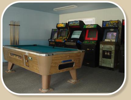Arcade with video games, pool table, and card tables
